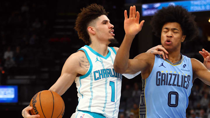Jan 22, 2025; Memphis, Tennessee, USA; Charlotte Hornets guard LaMelo Ball (1) drives to the basket as Memphis Grizzlies forward Jaylen Wells (0) defends during the first half at FedExForum. Mandatory Credit: Petre Thomas-Imagn Images