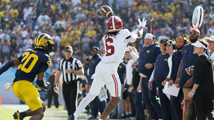 Dec 31, 2024; Tampa, FL, USA; Alabama Crimson Tide wide receiver Kobe Prentice (6) attempts to catch a pass inbounds over Michigan Wolverines defensive back Jyaire Hill (20) during the second half at Raymond James Stadium. 