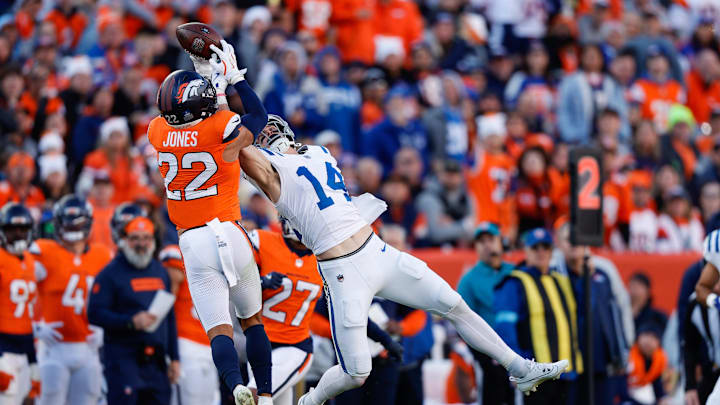 Denver Broncos safety Brandon Jones (22) intercepts a pass intended for Indianapolis Colts wide receiver Alec Pierce (14) in the second quarter at Empower Field at Mile High.