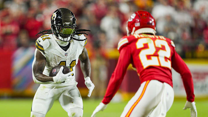 Oct 7, 2024; Kansas City, Missouri, USA; New Orleans Saints running back Alvin Kamara (41) runs the ball agaisnt Kansas City Chiefs cornerback Trent McDuffie (22) during the second half at GEHA Field at Arrowhead Stadium. Mandatory Credit: Jay Biggerstaff-Imagn Images