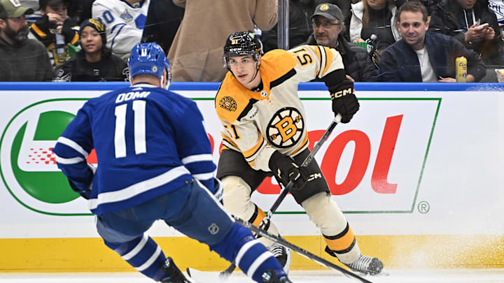 Dec 2, 2023; Toronto, Ontario, CAN; Boston Bruins forward Matthew Poitras (51) looks to make a play as Toronto Maple Leafs forward Max Domi (11) defends in the second period at Scotiabank Arena. Mandatory Credit: Dan Hamilton-Imagn Images