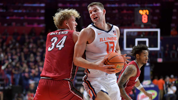 Nov 8, 2024; Champaign, Illinois, USA;  Illinois Fighting Illini center Tomislav Ivisic (13) drives to the basket against SIU Edwardsville Cougars center Arnas Sakenis (34) during the first half at State Farm Center. Mandatory Credit: Ron Johnson-Imagn Images