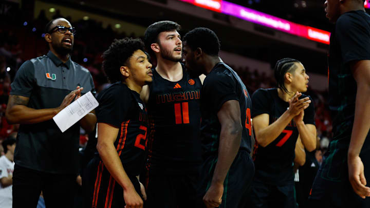 Jan 30, 2024; Raleigh, North Carolina, USA; Miami (Fl) Hurricanes guard Nijel Pack (24) celebrates with teammates during the second half against North Carolina State Wolfpack at PNC Arena. Mandatory Credit: Jaylynn Nash-USA TODAY Sports