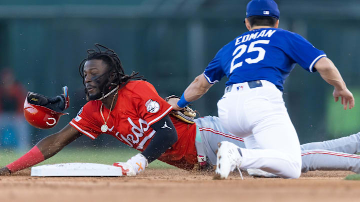 Mar 4, 2025; Phoenix, Arizona, USA; Cincinnati Reds shortstop Elly De La Cruz steals second base ahead of the tag by Los Angeles Dodgers second baseman Tommy Edman during a spring training game at Camelback Ranch-Glendale. Mandatory Credit: Mark J. Rebilas-Imagn Images
