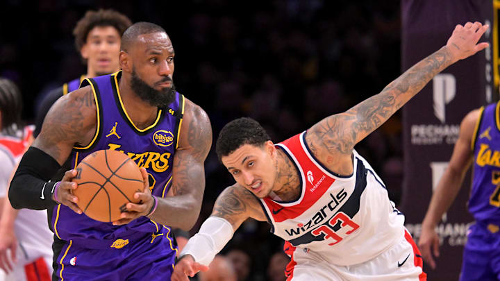 Jan 21, 2025; Los Angeles, California, USA;   Los Angeles Lakers forward LeBron James (23) passes in front of Washington Wizards guard Jordan Poole (13) at Crypto.com Arena. Mandatory Credit: Jayne Kamin-Oncea-Imagn Images