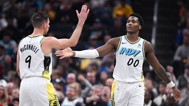 Dec 8, 2024; Indianapolis, Indiana, USA; Indiana Pacers guard T.J. McConnell (9) high-fives Indiana Pacers guard Bennedict Mathurin (00) after a play during the second half against the Charlotte Hornets at Gainbridge Fieldhouse. Mandatory Credit: Robert Goddin-Imagn Images 
