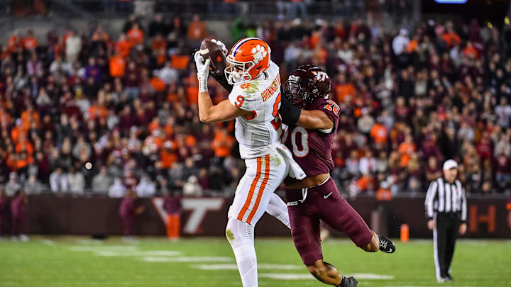 Nov 9, 2024; Blacksburg, Virginia, USA; Clemson Tigers tight end Jake Briningstool (9) catches a pass while being defended by Virginia Tech Hokies linebacker Caleb Woodson (20) during the fourth quarter at Lane Stadium. Nov 9, 2024; Blacksburg, Virginia, USA; Clemson Tigers tight end Jake Briningstool (9) catches a pass while being defended by Virginia Tech Hokies linebacker Caleb Woodson (20) during the fourth quarter at Lane Stadium.