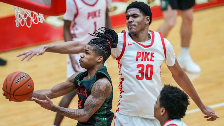 Lawrence North Wildcats guard Cameron Webster (2) goes up for a basket against Pike Red Devils Isaiah Hill (30).