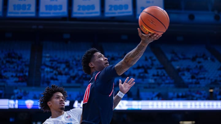Nov 11, 2025; Chapel Hill, North Carolina, USA; Radford Highlanders guard Del Jones (10) lays up against North Carolina Tar Heels forward Jonathan Powell (11) during the first half at Dean E. Smith Center. Mandatory Credit: Scott Kinser-Imagn Images