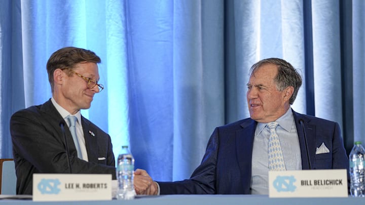 Dec 12, 2024; Chapel Hill, NC, USA;  North Carolina Tar Heels new head coach Bill Belichick shakes hands with chancellor Lee Roberts at Loudermilk Center for Excellence. Mandatory Credit: Jim Dedmon-Imagn Images