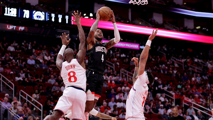 Nov 13, 2024; Houston, Texas, USA; Houston Rockets guard Jalen Green (4) shoots against LA Clippers guard Kris Dunn (8) during the fourth quarter at Toyota Center. Mandatory Credit: Erik Williams-Imagn Images