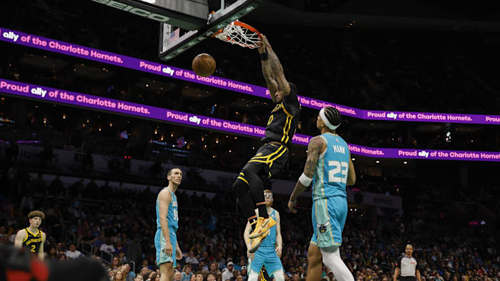 Golden State Warriors guard Gary Payton II (0) dunks against the Charlotte Hornets at Spectrum Center. 