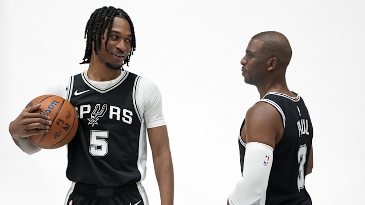Sep 30, 2024; San Antonio, TX, USA; San Antonio Spurs guards Stephon Castle (5) and Chris Paul (3) pose for photos during Media day at Victory Capital Performance Center in San Antonio. Mandatory Credit: Scott Wachter-Imagn Images