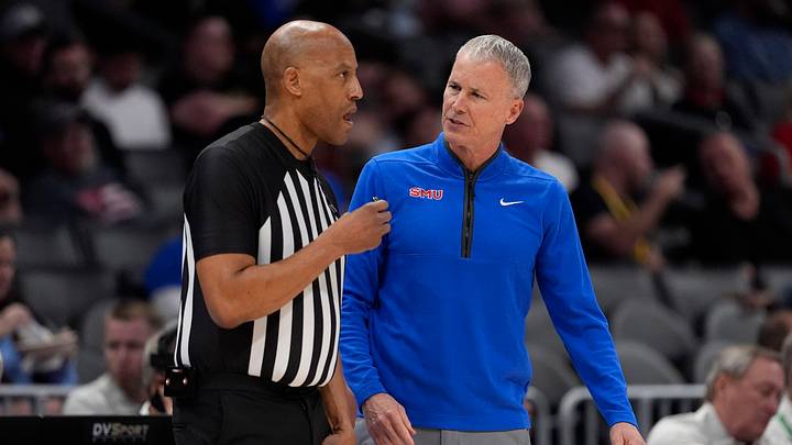 Mar 11, 2026; Charlotte, NC, USA; Southern Methodist University Mustangs head coach Andy Enfield talks with an official during the first half against the Louisville Cardinals at Spectrum Center. Mandatory Credit: Jim Dedmon-Imagn Images