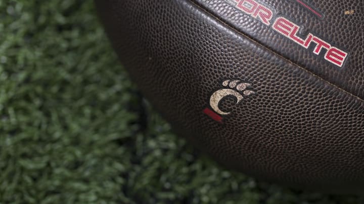 Sep 6, 2025; Cincinnati, Ohio, USA; The Cincinnati logo is seen on a football before the game between the Bowling Green Falcons and the Cincinnati Bearcats at Nippert Stadium. Mandatory Credit: Aaron Doster-Imagn Images Sep 6, 2025; Cincinnati, Ohio, USA; The Cincinnati logo is seen on a football before the game between the Bowling Green Falcons and the Cincinnati Bearcats at Nippert Stadium. Mandatory Credit: Aaron Doster-Imagn Images