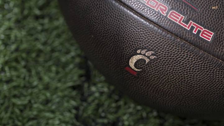 Sep 6, 2025; Cincinnati, Ohio, USA; The Cincinnati logo is seen on a football before the game between the Bowling Green Falcons and the Cincinnati Bearcats at Nippert Stadium. Mandatory Credit: Aaron Doster-Imagn Images