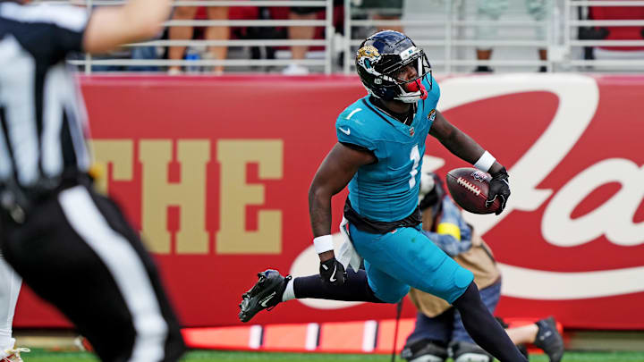 Sep 28, 2025; Santa Clara, California, USA; Jacksonville Jaguars running back Travis Etienne Jr. (1) scores a touchdown during the second half against the San Francisco 49ers at Levi's Stadium. Mandatory Credit: Darren Yamashita-Imagn Images