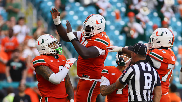 Sep 7, 2024; Miami Gardens, Florida, USA; Miami Hurricanes tight end Elijah Arroyo (8) celebrates with Miami Hurricanes offensive lineman Markel Bell (70) after scoring a touchdown against Florida A&M Rattlers during the first quarter at Hard Rock Stadium. Mandatory Credit: Sam Navarro-Imagn Images
