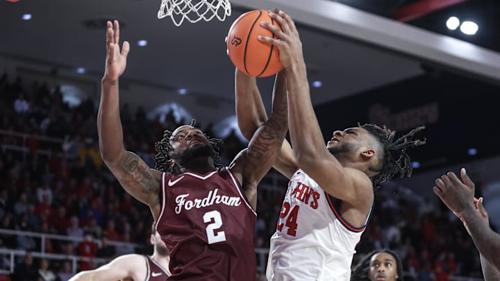 Nov 4, 2024; Queens, New York, USA;  Fordham Rams forward Romad Dean (2) and St. John's Red Storm forward Zuby Ejiofor (24) fight for a rebound in the second half at Carnesecca Arena. Mandatory Credit: Wendell Cruz-Imagn Images