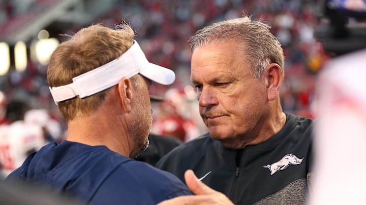 Former Liberty Flames coach Hugh Freeze, left, talks to Arkansas Razorbacks coach Sam Pittman after the game at Donald W. Reynolds Razorback Stadium. Liberty won 21-19.