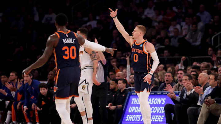Jan 25, 2024; New York, New York, USA; New York Knicks guard Donte DiVincenzo (0) celebrates his three point shot against the Denver Nuggets with forward Julius Randle (30) during the first quarter at Madison Square Garden. Mandatory Credit: Brad Penner-Imagn Images