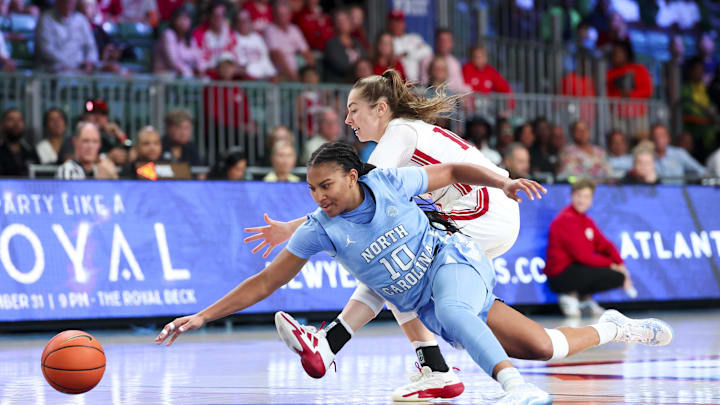 Nov 25, 2024; Paradise Island, Bahamas, BHS; North Carolina Tar Heels guard Reniya Kelly (10) and Indiana Hoosiers guard Shay Ciezki (10) go for a loose ball during the second half at the Atlantis Resort. Mandatory Credit: Kevin Jairaj-Imagn Images