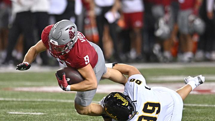 Aug 30, 2025; Pullman, Washington, USA; Washington State Cougars running back Kirby Vorhees (9) is tackled in the backfield by Idaho Vandals defensive lineman Trevor Miller (99) in the first half at Gesa Field at Martin Stadium. Aug 30, 2025; Pullman, Washington, USA; Washington State Cougars running back Kirby Vorhees (9) is tackled in the backfield by Idaho Vandals defensive lineman Trevor Miller (99) in the first half at Gesa Field at Martin Stadium.