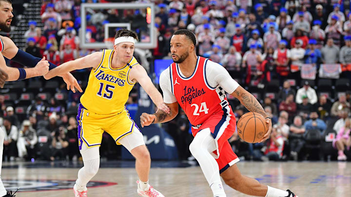 Feb 4, 2025; Inglewood, California, USA; Los Angeles Clippers guard Norman Powell (24) moves the ball against Los Angeles Lakers guard Austin Reaves (15) during the first half at Intuit Dome. Mandatory Credit: Gary A. Vasquez-Imagn Images Feb 4, 2025; Inglewood, California, USA; Los Angeles Clippers guard Norman Powell (24) moves the ball against Los Angeles Lakers guard Austin Reaves (15) during the first half at Intuit Dome. Mandatory Credit: Gary A. Vasquez-Imagn Images