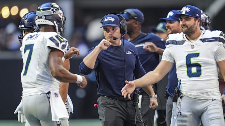 Oct 20, 2024; Atlanta, Georgia, USA; Seattle Seahawks head coach Mike Macdonald reacts with quarterback Geno Smith (7) after a touchdown against the Atlanta Falcons at Mercedes-Benz Stadium. Mandatory Credit: Dale Zanine-Imagn Images