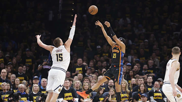 May 7, 2025; Oklahoma City, Oklahoma, USA; Oklahoma City Thunder guard Aaron Wiggins (21) shoots over Denver Nuggets center Nikola Jokic (15) in the second quarter during game two of the second round for the 2025 NBA Playoffs at Paycom Center. Mandatory Credit: Alonzo Adams-Imagn Images