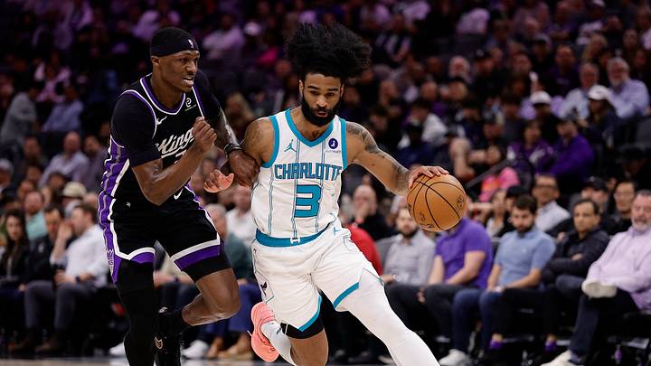 Charlotte Hornets guard Coby White (3) controls the ball against Sacramento Kings guard Killian Hayes 