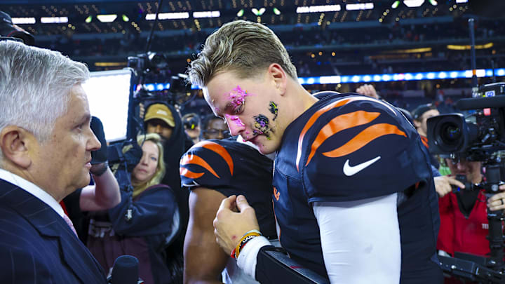 Dec 9, 2024; Arlington, Texas, USA;  Cincinnati Bengals wide receiver Ja'Marr Chase (1) smashes a donut on the face of Cincinnati Bengals quarterback Joe Burrow (9) after the game against the Dallas Cowboys at AT&T Stadium. Mandatory Credit: Kevin Jairaj-Imagn Images