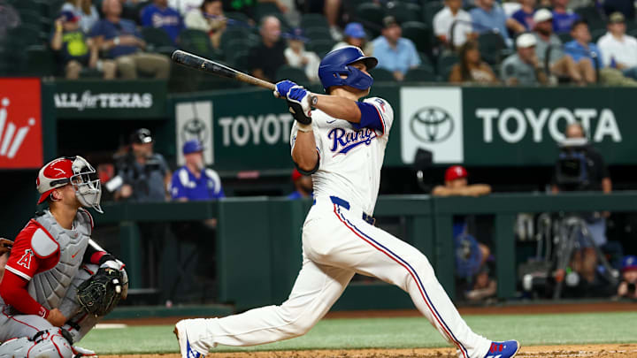 Aug 27, 2025; Arlington, Texas, USA;  Texas Rangers shortstop Corey Seager (5) hits a two-run home run during the fourth inning against the Los Angeles Angels at Globe Life Field. 