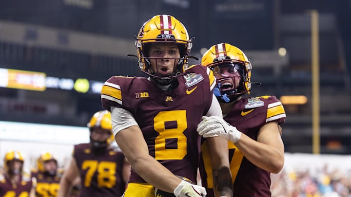 Dec 26, 2025; Phoenix, AZ, USA; Minnesota Gophers wide receiver Jalen Smith (8) celebrates with teammate Logan Loya (17) after catching the game winning touchdown pass against the New Mexico Lobos during overtime of the Rate Bowl at Chase Field. Mandatory Credit: Mark J. Rebilas-Imagn Images