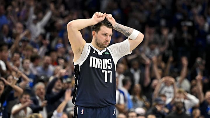 Apr 26, 2024; Dallas, Texas, USA; Dallas Mavericks guard Luka Doncic (77) reacts to a three point shot made by guard Kyrie Irving (not pictured) during the fourth quarter against the LA Clippers during game three of the first round for the 2024 NBA playoffs at the American Airlines Center. Mandatory Credit: Jerome Miron-Imagn Images
