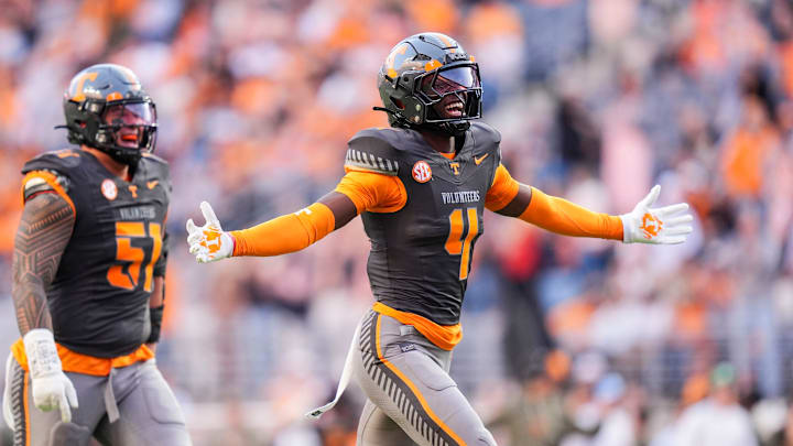 Tennessee defensive back Ty Redmond (4) and defensive lineman Jaxson Moi (51) celebrate after Redmond made an interception against New Mexico State during an NCAA college football game on November 15, 2025, in Knoxville, Tenn.