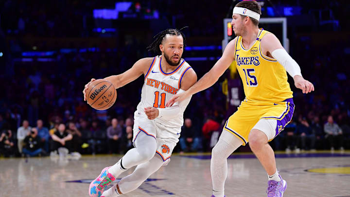 Mar 6, 2025; Los Angeles, California, USA;  New York Knicks guard Jalen Brunson (11) moves the ball against Los Angeles Lakers guard Austin Reaves (15) during the first half at Crypto.com Arena. Mandatory Credit: Gary A. Vasquez-Imagn Images