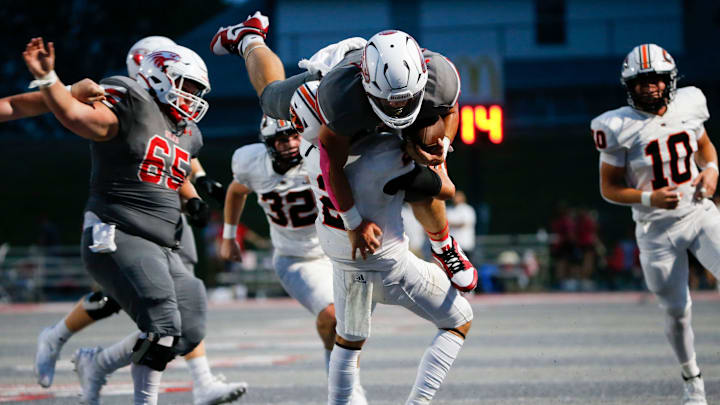 Nixa's Dylan Rebura is picked up by Republic's Ryder Davis as the Eagles took on the Tigers at Nixa on Friday, Aug. 30, 2024.
