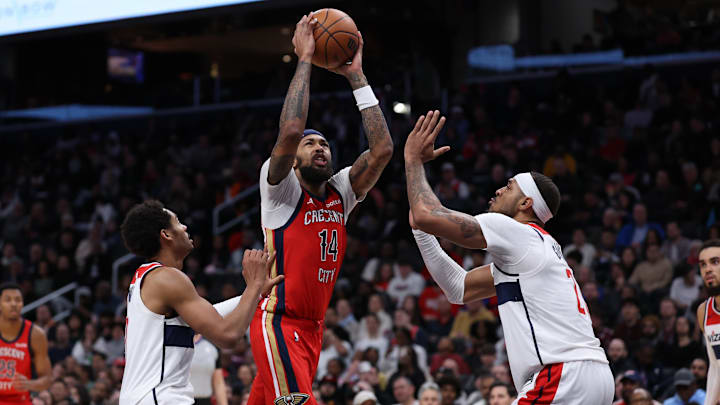 Dec 13, 2023; Washington, District of Columbia, USA; New Orleans Pelicans forward Brandon Ingram (14) drives to the basket as Washington Wizards center Daniel Gafford (21) and Wizards guard Jordan Poole (13) defend in the fourth quarter at Capital One Arena. Mandatory Credit: Geoff Burke-Imagn Images