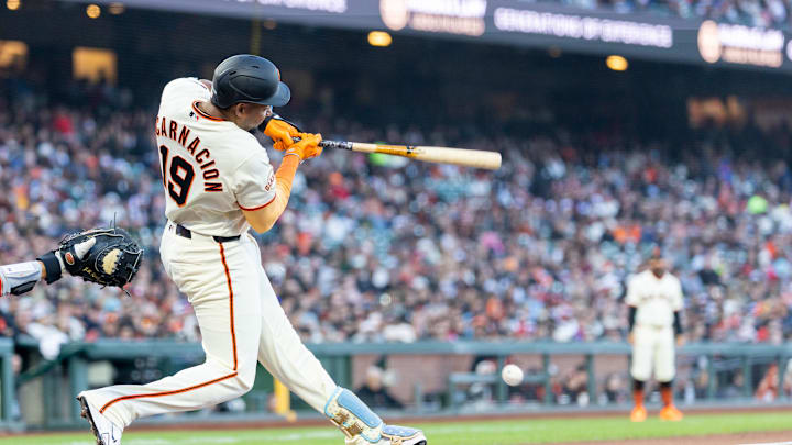 Apr 6, 2026; San Francisco, California, USA; San Francisco Giants right fielder Jerar Encarnacion (19) grounds to get on base during the second inning against the Philadelphia Phillies at Oracle Park. Mandatory Credit: Bob Kupbens-Imagn Images