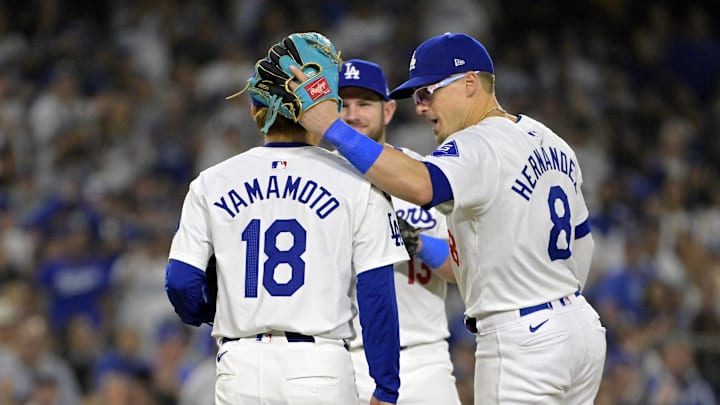 Oct 26, 2024; Los Angeles, California, USA; Los Angeles Dodgers outfielder Enrique Hernandez (8) meets pitcher Yoshinobu Yamamoto (18) on the mound in the seventh inning against the New York Yankees during game two of the 2024 MLB World Series at Dodger Stadium. Mandatory Credit: Jayne Kamin-Oncea-Imagn Images