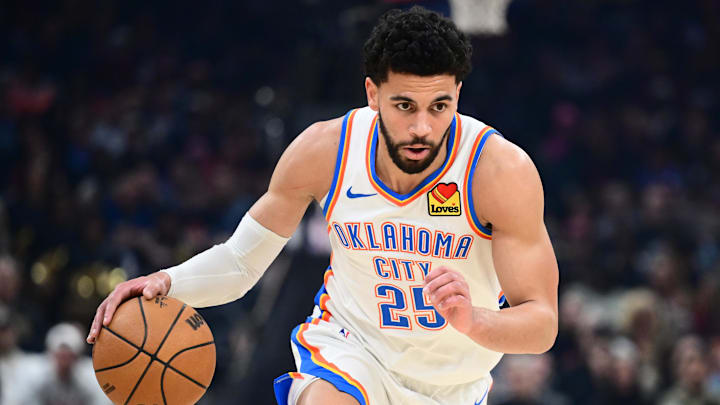 Jan 19, 2026; Cleveland, Ohio, USA; Oklahoma City Thunder guard Ajay Mitchell (25) brings the ball up court against the Cleveland Cavaliers during the first half at Rocket Arena.