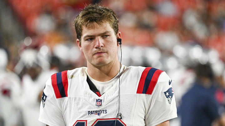 Aug 25, 2024; Landover, Maryland, USA;  New England Patriots quarterback Drake Maye (10) stands in the bench area during the second  half against the Washington Commanders at Commanders Field.