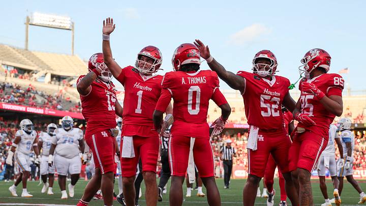 Sep 12, 2026; Houston, Texas, USA; Houston Cougars wide receiver Amare Thomas (0) celebrates and quarterback Conner Weigman (1) waves to the crowd after a touchdown during the first quarter against the Southern University Jaguars at TDECU Stadium. Mandatory Credit: Troy Taormina-Imagn Images Sep 12, 2026; Houston, Texas, USA; Houston Cougars wide receiver Amare Thomas (0) celebrates and quarterback Conner Weigman (1) waves to the crowd after a touchdown during the first quarter against the Southern University Jaguars at TDECU Stadium. Mandatory Credit: Troy Taormina-Imagn Images