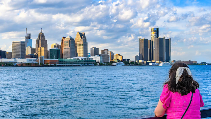 A female tourist looking at the Detroit cityscape or skyline...