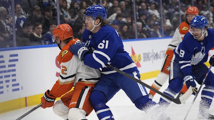 Mar 12, 2026; Toronto, Ontario, CAN; Toronto Maple Leafs forward Michael Pezzetta (61) checks Anaheim Ducks defenseman Jackson LaCombe (2) during the third period at Scotiabank Arena. Mandatory Credit: John E. Sokolowski-Imagn Images