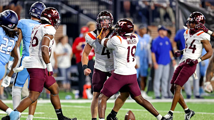 Sep 2, 2022; Norfolk, Virginia, USA;  Virginia Tech Hokies linebacker Dax Hollifield (4) celebrates with Virginia Tech Hokies linebacker J.R. Walker (19) after recovering a fumble at Kornblau Field at S.B. Ballard Stadium. Mandatory Credit: Peter Casey-USA TODAY Sports
