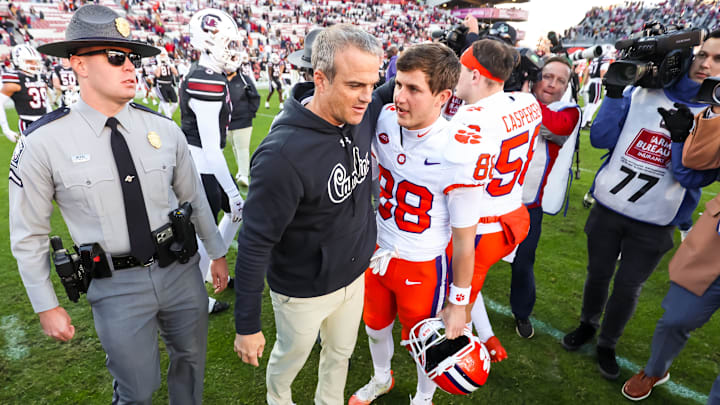 Nov 29, 2025; Columbia, South Carolina, USA; South Carolina Gamecocks head coach Shane Beamer speaks with Clemson Tigers wide receiver Clay Swinney (88), the son of Clemson Tigers head coach Dabo Swinney, following the Tigers 28-14 win at Williams-Brice Stadium. Mandatory Credit: Jeff Blake-Imagn Images Nov 29, 2025; Columbia, South Carolina, USA; South Carolina Gamecocks head coach Shane Beamer speaks with Clemson Tigers wide receiver Clay Swinney (88), the son of Clemson Tigers head coach Dabo Swinney, following the Tigers 28-14 win at Williams-Brice Stadium. Mandatory Credit: Jeff Blake-Imagn Images