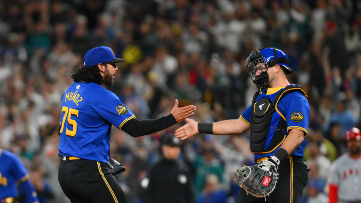 Seattle Mariners relief pitcher Andres Munoz (75) and catcher Cal Raleigh (29) celebrate defeating the Los Angeles Angels at T-Mobile Park on May 31. Seattle Mariners relief pitcher Andres Munoz (75) and catcher Cal Raleigh (29) celebrate defeating the Los Angeles Angels at T-Mobile Park on May 31.