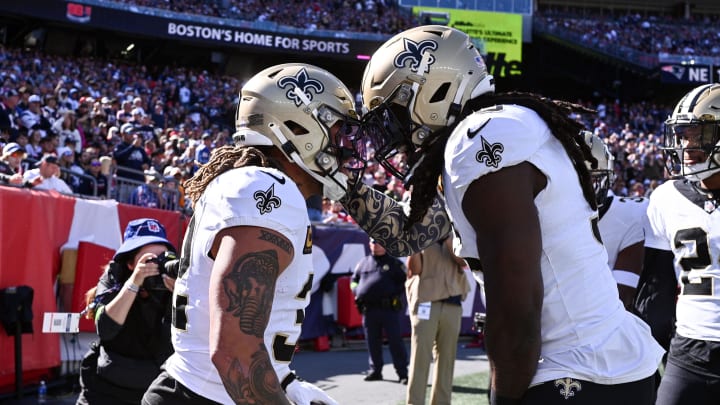 Oct 8, 2023; Foxborough, Massachusetts, USA; New Orleans Saints safety Tyrann Mathieu (32) celebrates with linebacker Demario Davis (56) after scoring a touchdown on an interception during the first half of a game against the New England Patriots at Gillette Stadium. Mandatory Credit: Brian Fluharty-USA TODAY Sports